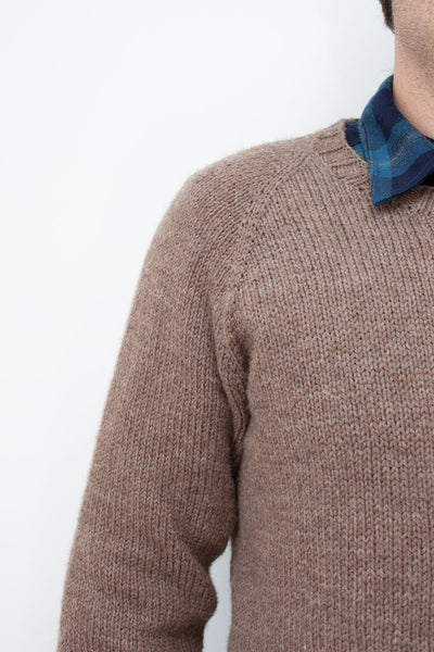 Load image into Gallery viewer, close up of raglan increases on hand knit sweater worn by a man in a flannel blue collared shirt
